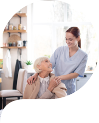 a caregiver and an elderly woman staring each other and both smiling