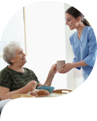 a caregiver assisting elderly woman for the food