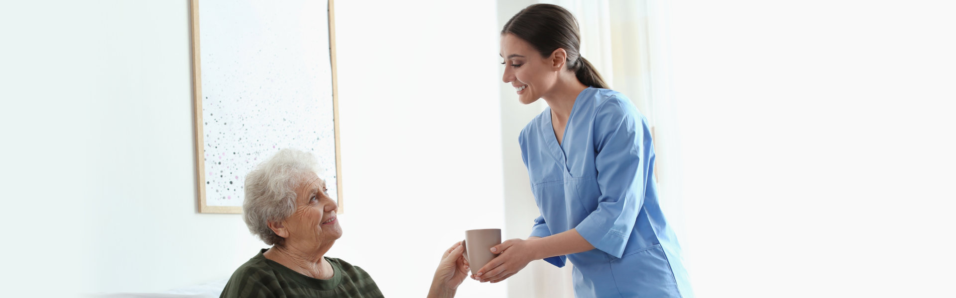 a caregiver assisting elderly woman for the food