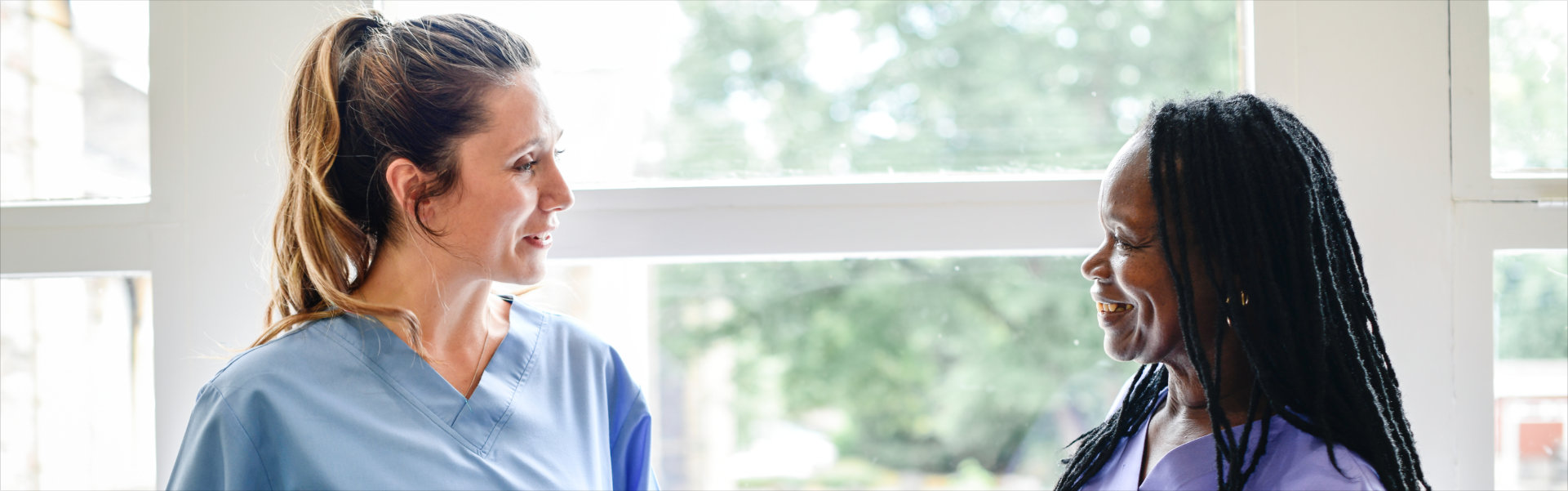 caregivers having a conversation in the hospital hallway