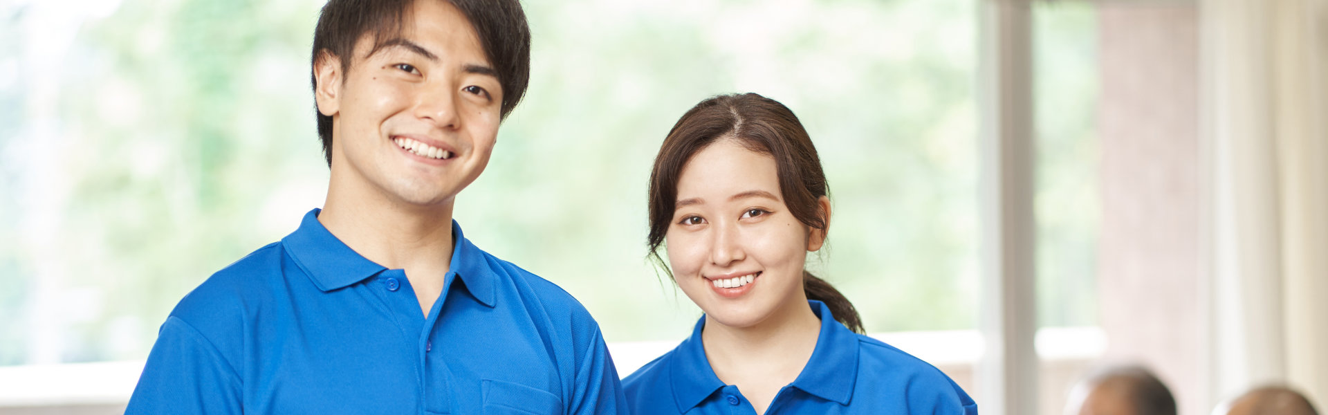 two caregiver staff smiling